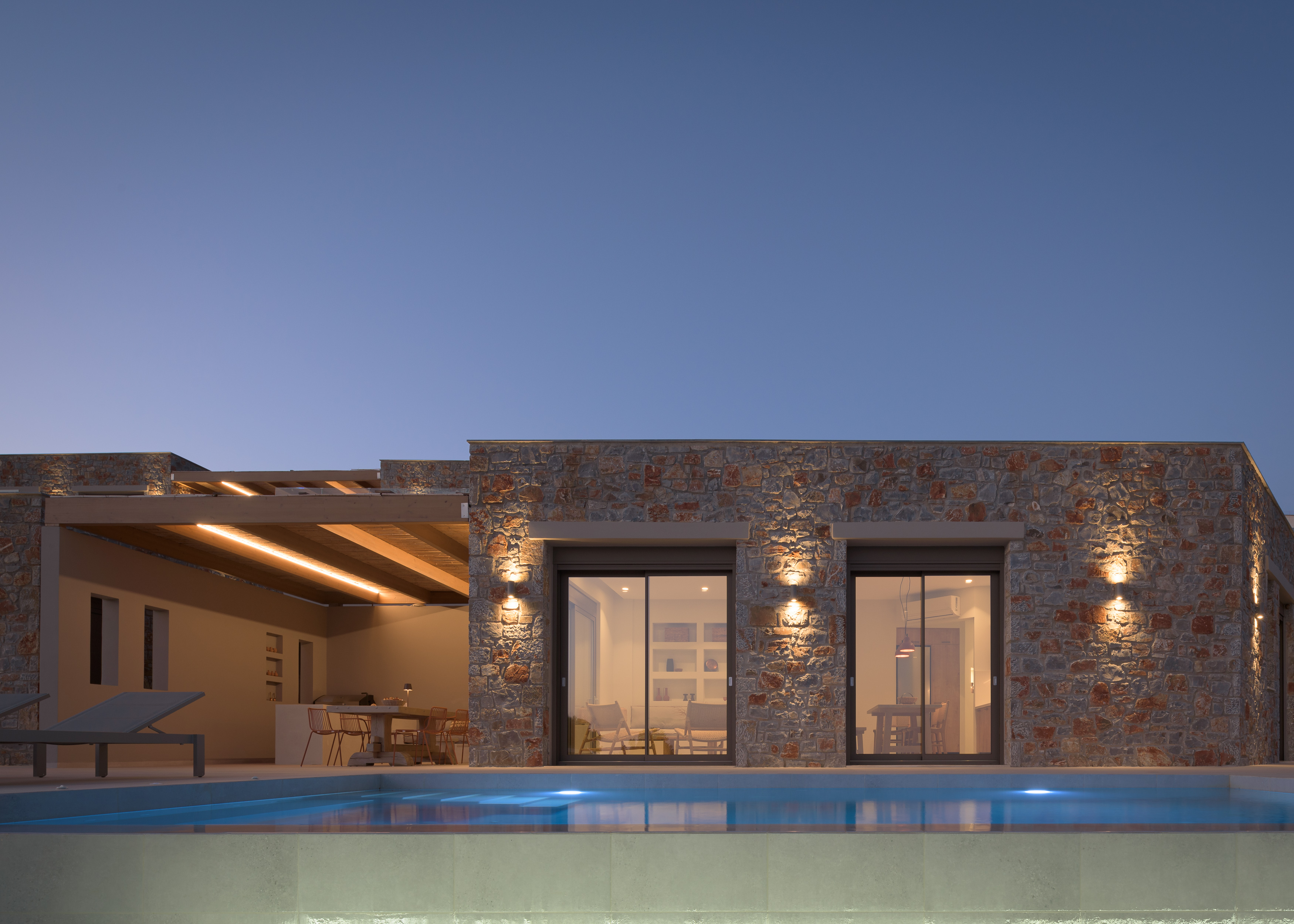 Experience the villa’s beauty by night, with the pool glowing under the stars.