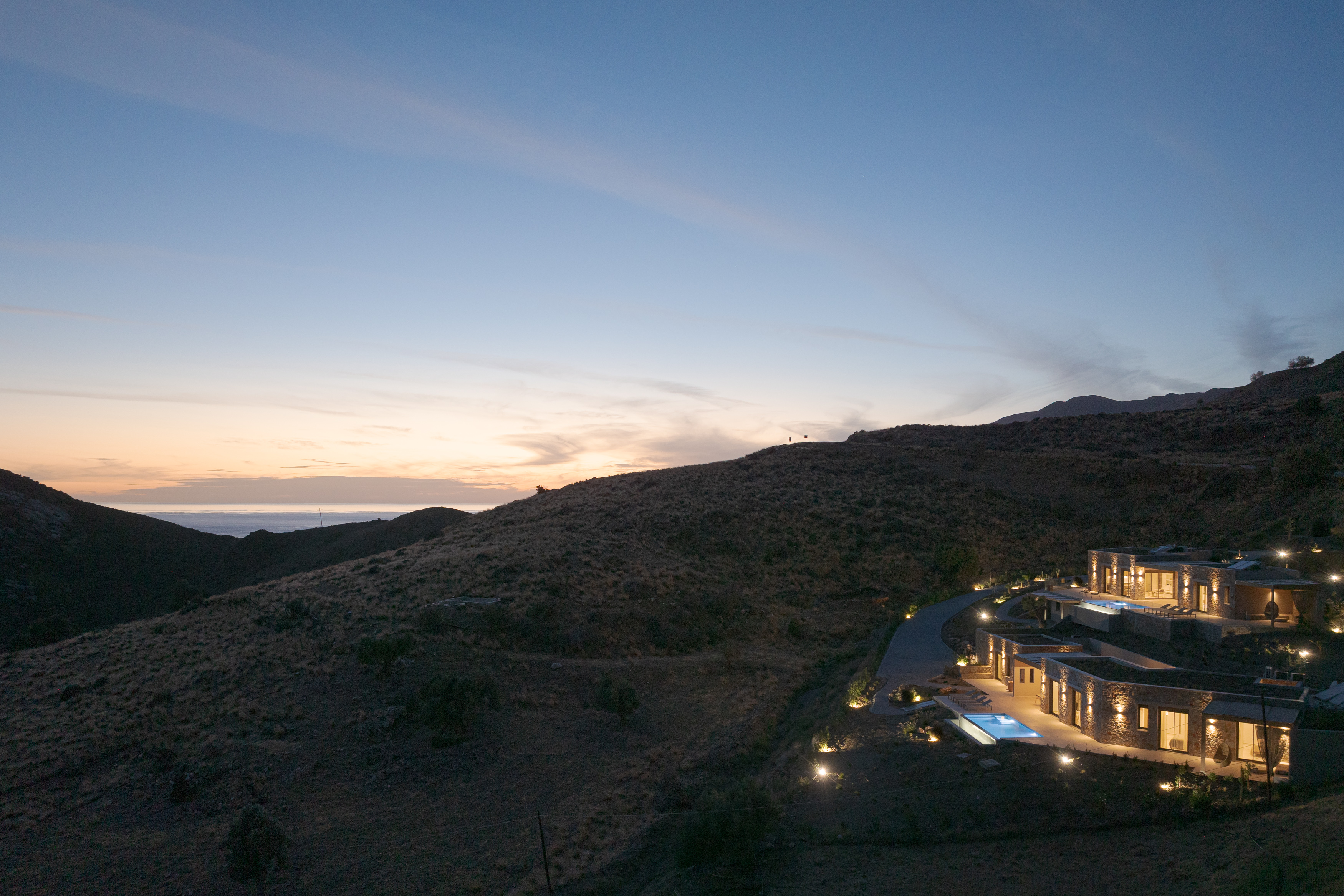 Reflected in the calm night, the villa shines with elegance and charm.